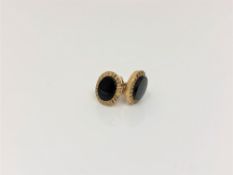 A pair of 9ct gold onyx earrings.