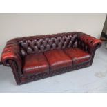 A three seater red button leather Chesterfield club settee CONDITION REPORT: