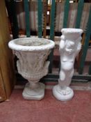 A concrete classical urn together with a chalk cherub fountain base