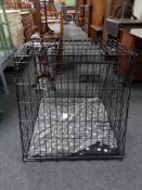 A folding metal dog cage, with liner and blanket,