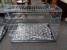 A folding metal dog cage, with liner and blanket,