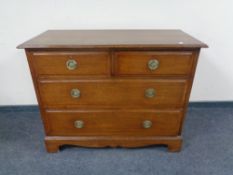 An Edwardian oak four drawer chest