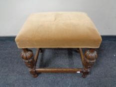 An Edwardian carved oak dressing table stool