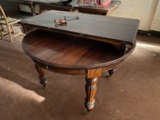 A reproduction Victorian style circular wind out dining table with leaf and handle
