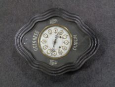 An early 20th century pine cased brass and enamelled wall clock bearing Guinness advertisement