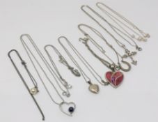 Eight silver pendants on chains (8)