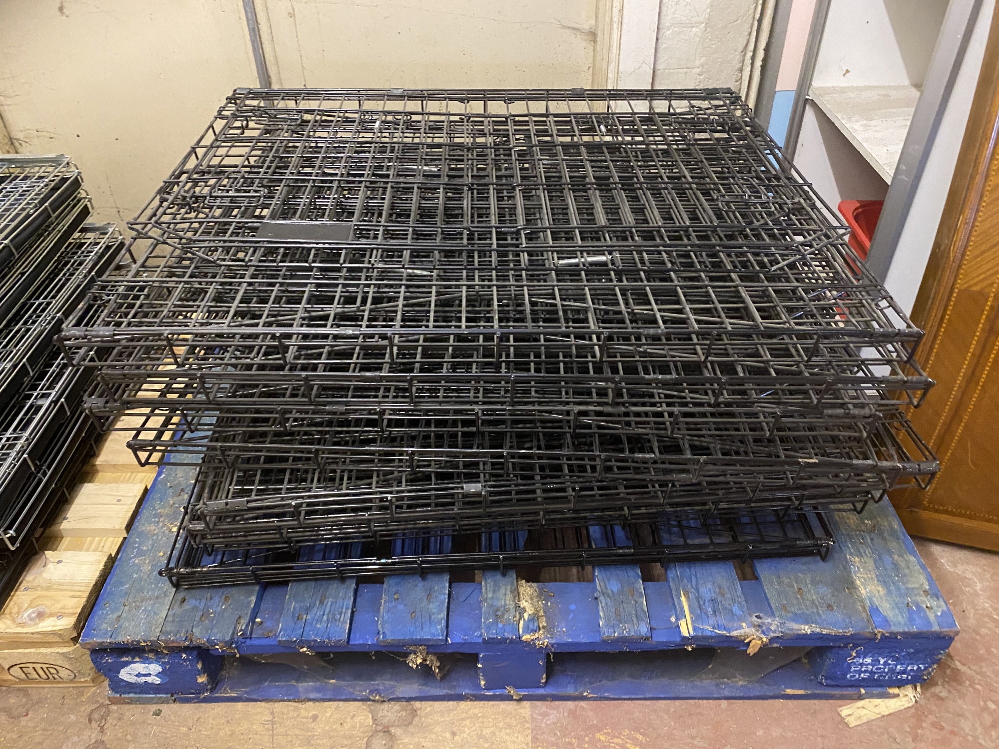 A pallet of eight metal dog cages,