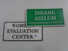 Two cast iron signs - Insane Asylum and Women's Evaluation