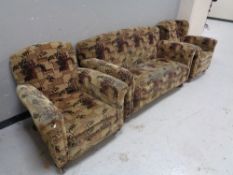 An Edwardian three piece lounge suite in a brown print