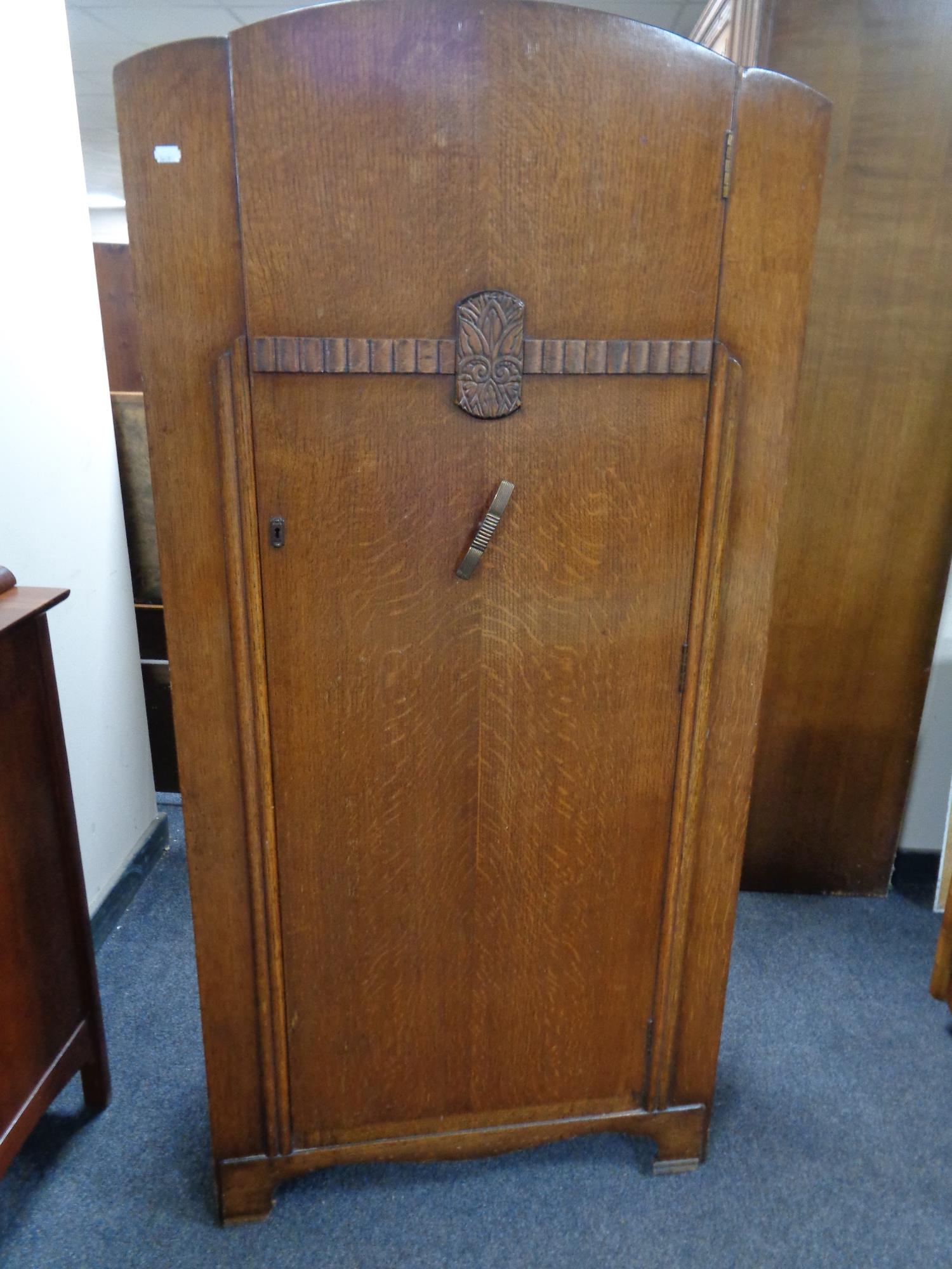 A 1930's oak single door wardrobe