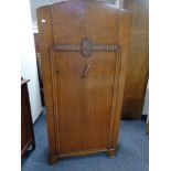 A 1930's oak single door wardrobe