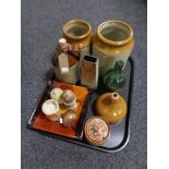 A tray of antique glazed pottery storage jars and bottles, onyx egg, cup,