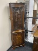 A mahogany corner display cabinet and a nest of three inlaid tables