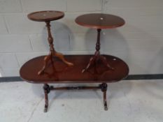 An inlaid mahogany oval coffee table on brass castors with two wine tables (3)