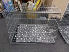 A folding metal dog cage, with liner and blanket,