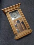 An early 20th century oak cased eight day wall clock with silvered dial,