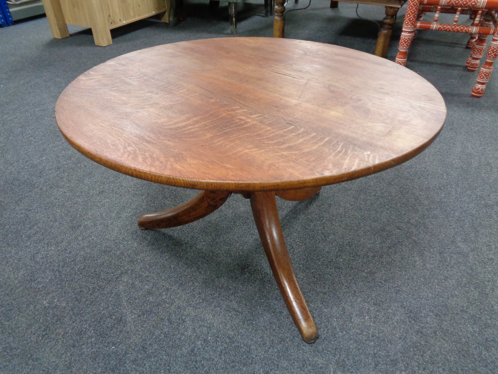 A circular pedestal coffee table