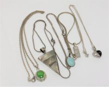 Five silver pendants on chains (5)