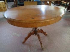 A 19th century oval oak pedestal occasional table on carved four-way support,