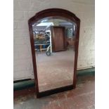An antique mahogany framed beveled mirror