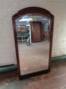 An antique mahogany framed beveled mirror