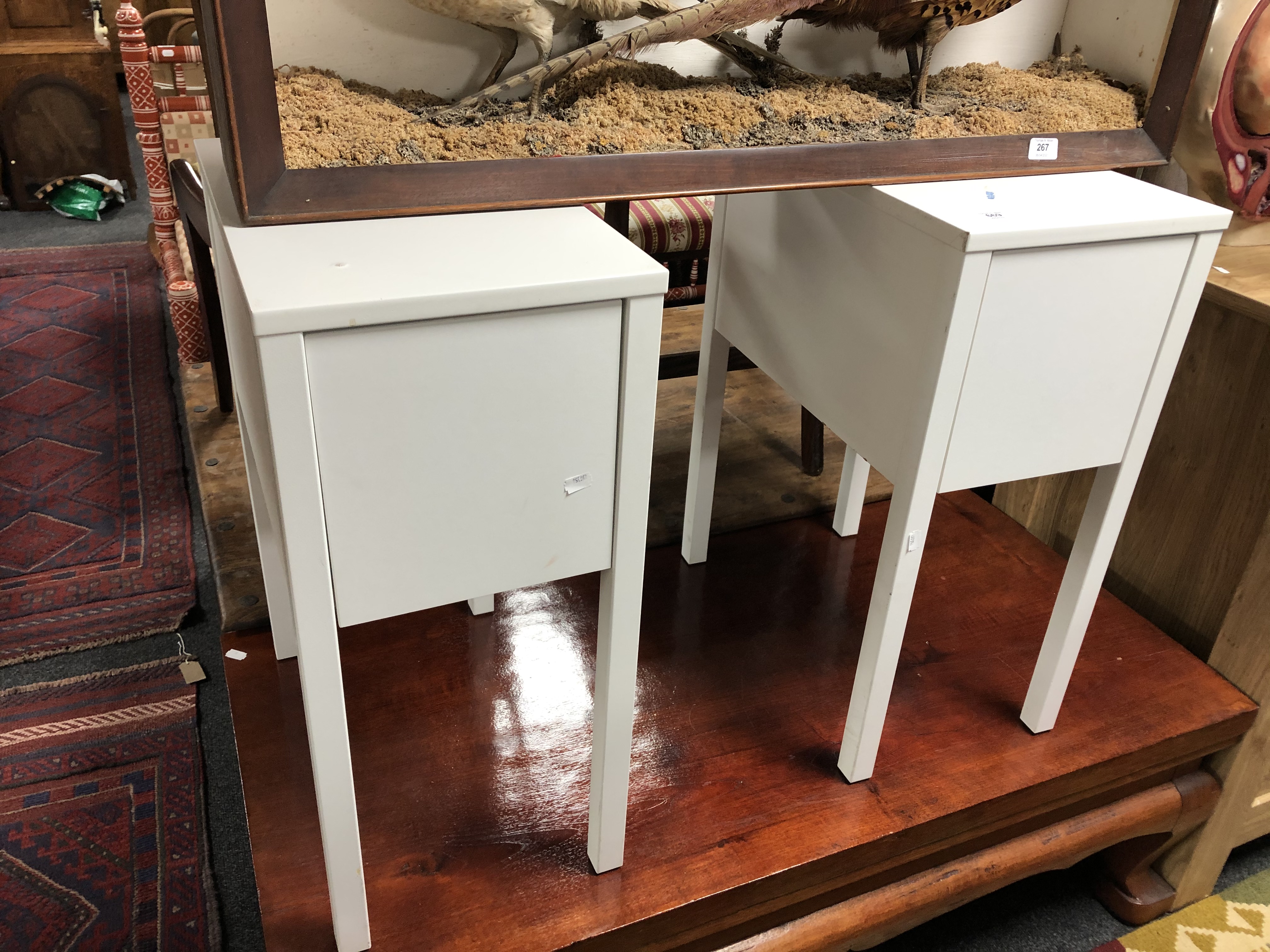 A pair of contemporary white bedside stands fitted a drawer