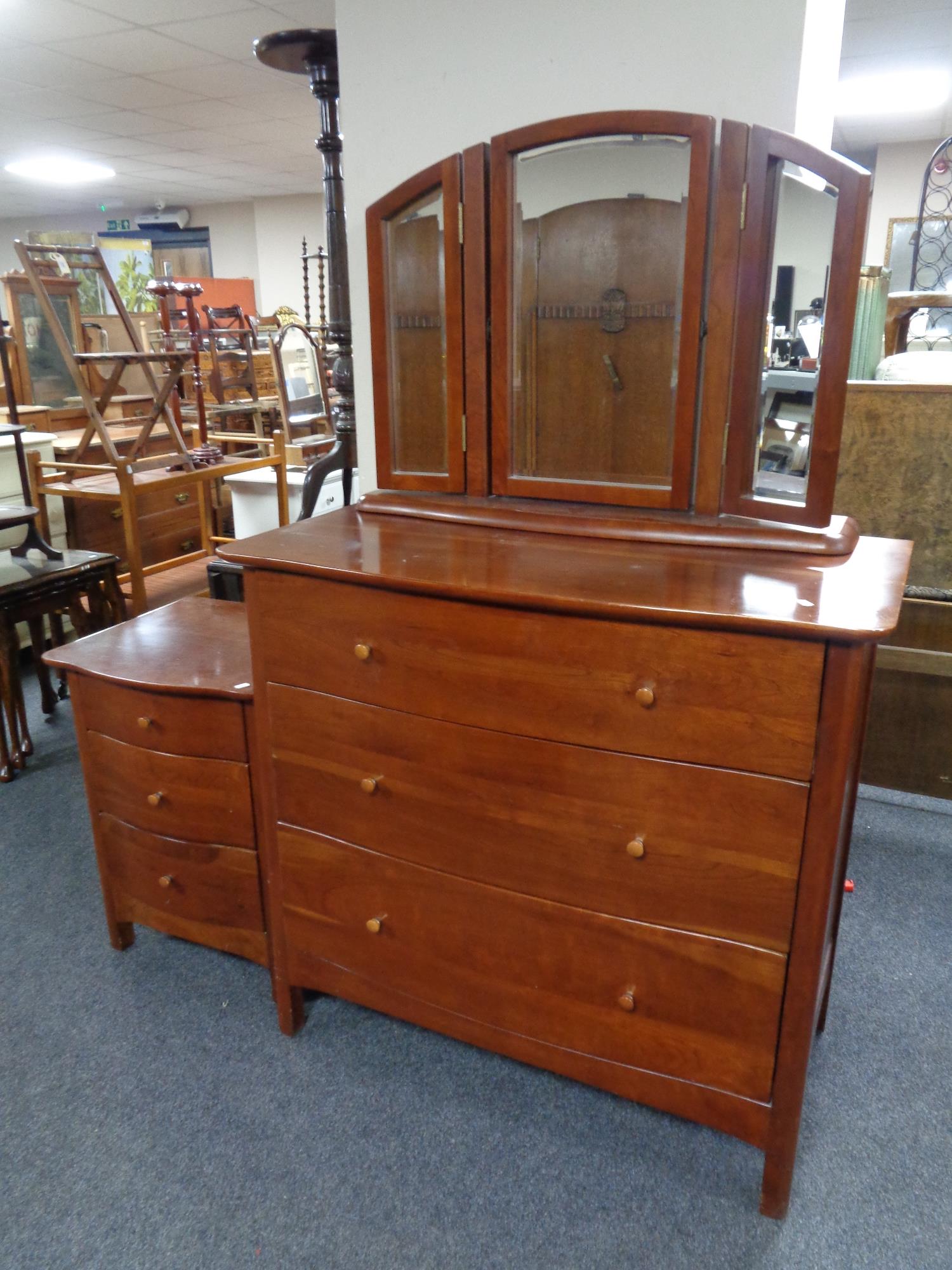 A Willis & Gambier three drawer serpentine fronted chest with triple mirror and matching bedside