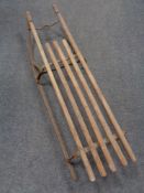 A 20th century metal wooden slatted sledge