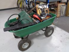 A garden trolley of garden tools including hedge trimmer, hammer drill,