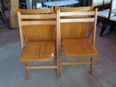 A set of four folding kitchen chairs
