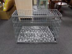 A folding metal dog cage, with liner and blanket,