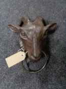 A cast iron door knocker modelled as a goat head