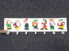 A cast iron cup rack modelled as the seven dwarves