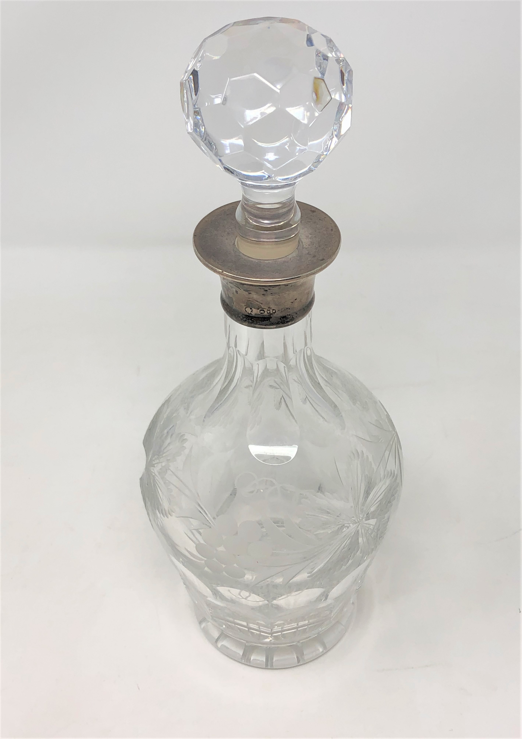 A good quality silver mounted decanter engraved with grapes and vines