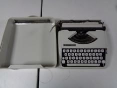 A cased Hermes Baby typewriter