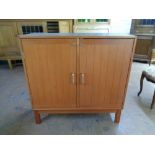 A mid 20th century teak double door office cabinet, 95cm wide by 40cm deep by 95cm high.