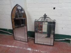 A metal framed leaded glass arch top mirror together with one other wrought iron framed leaded