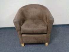 A tub chair in brown suede effect fabric
