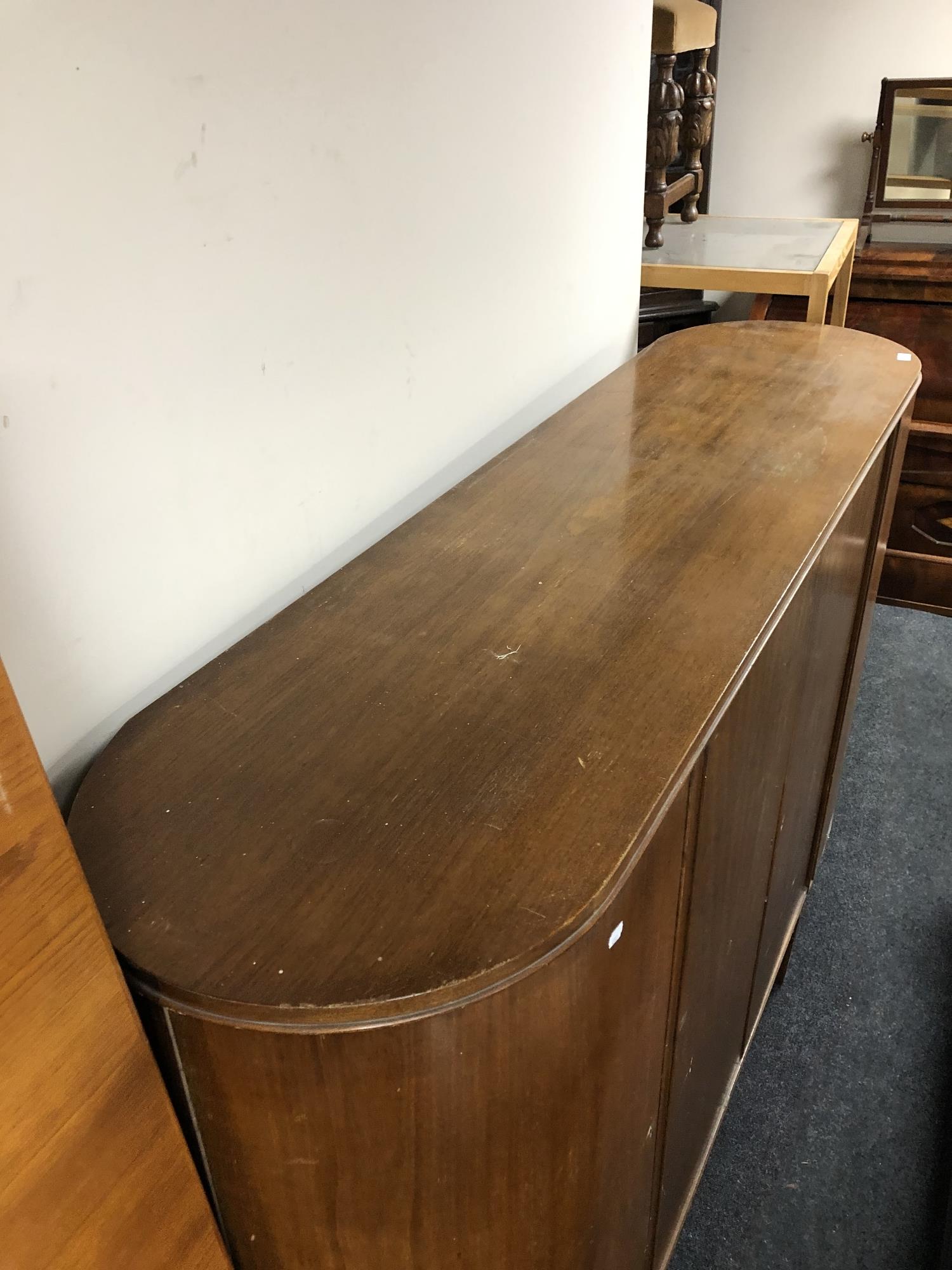 A mid 20th century teak four door sideboard on raised legs - Image 5 of 6