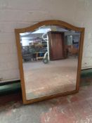 An early 20th century arch topped gilt framed bevelled edge mirror