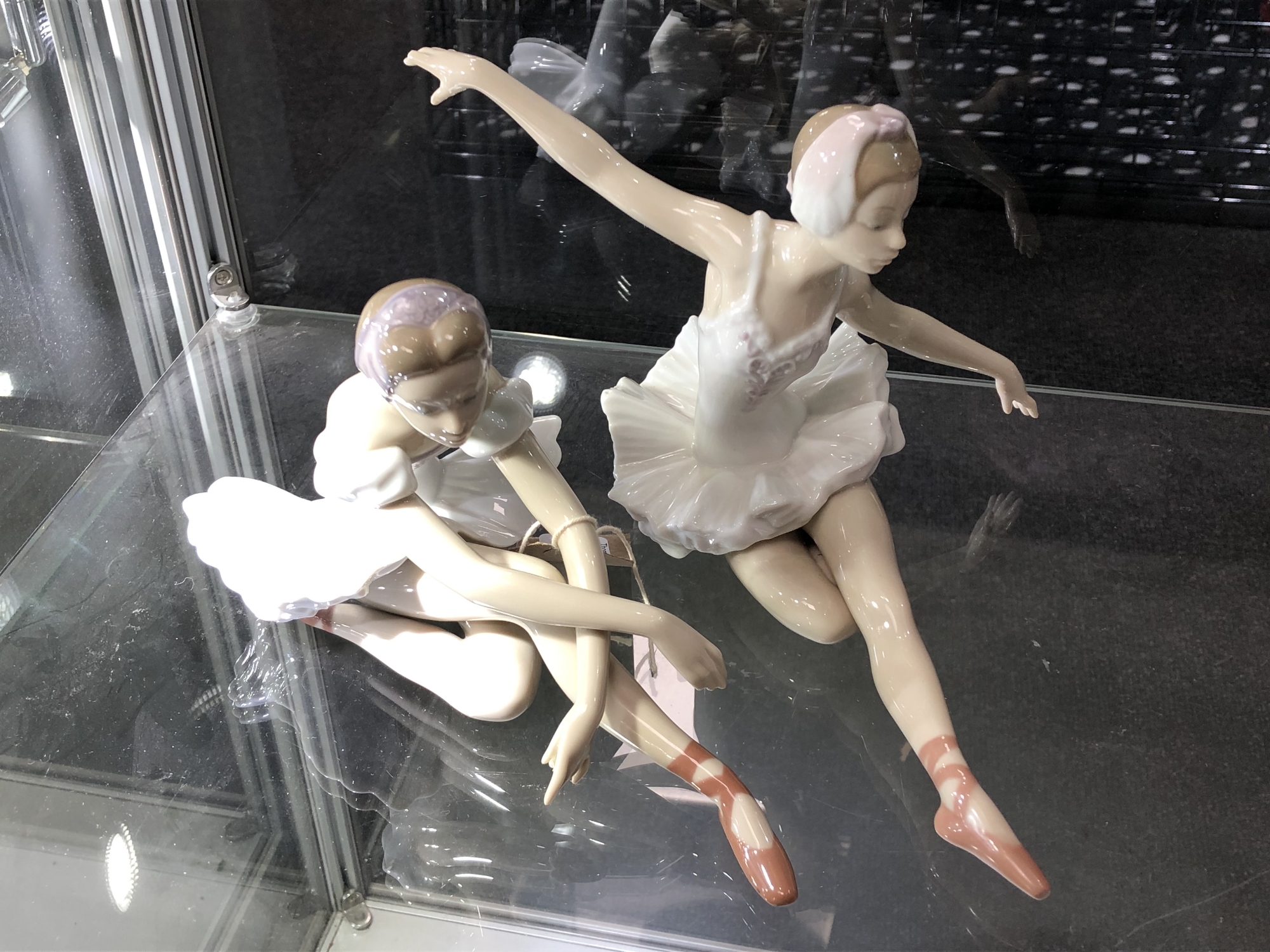 Two Lladro figures of seated ballerinas (as found)