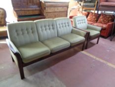 A 20th century wood framed three seater settee and armchair upholstered in green buttoned dralon