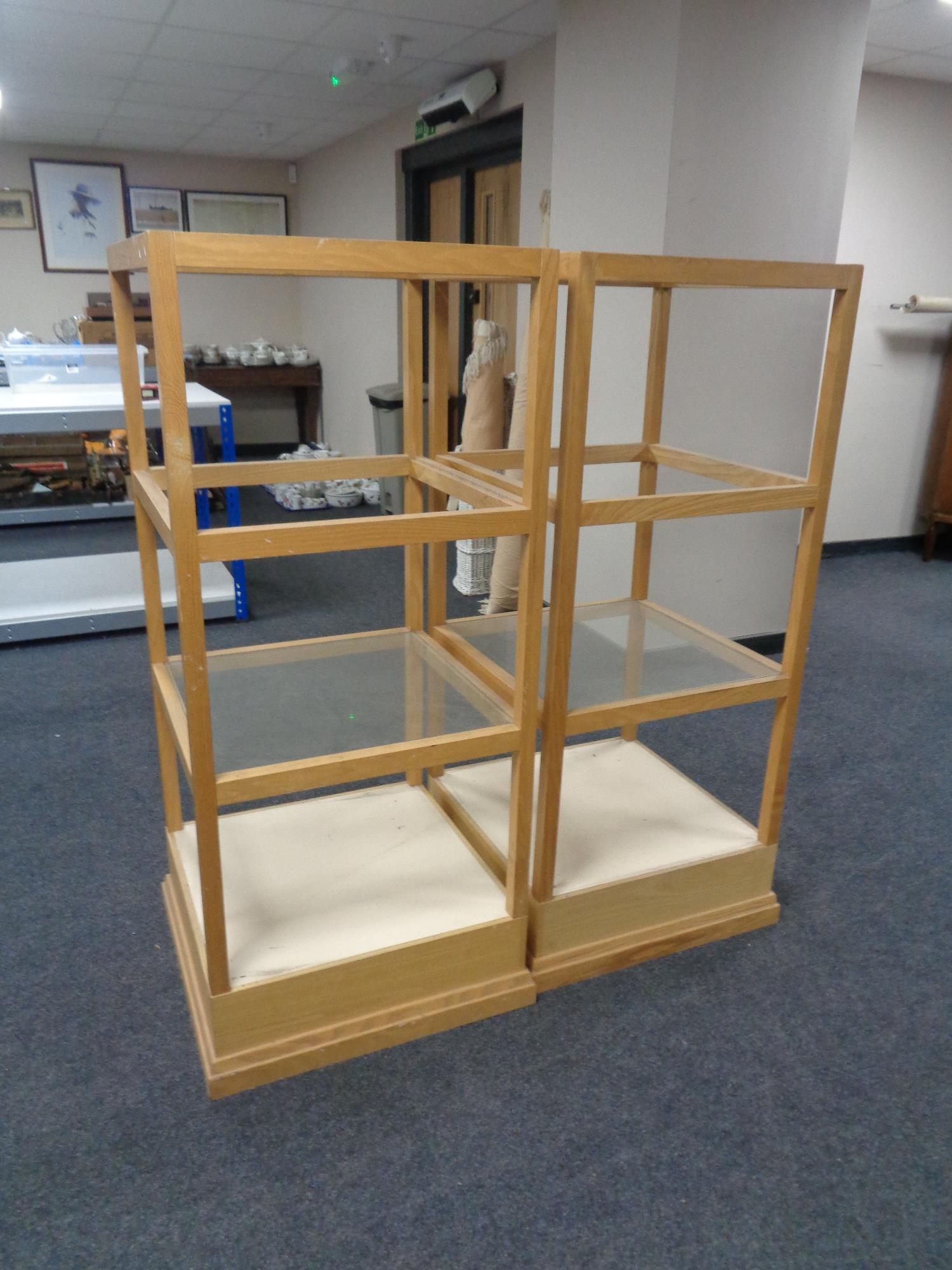 A pair of four tier square shop display stands (missing two glass shelves)