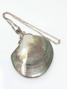 A silver mounted polished shell pendant on chain