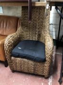 A rattan high back armchair