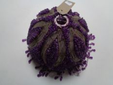 A purple beaded glass light shade