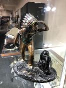 A hand painted metal figure of a native American