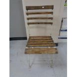 A folding metal wooden slatted garden chair
