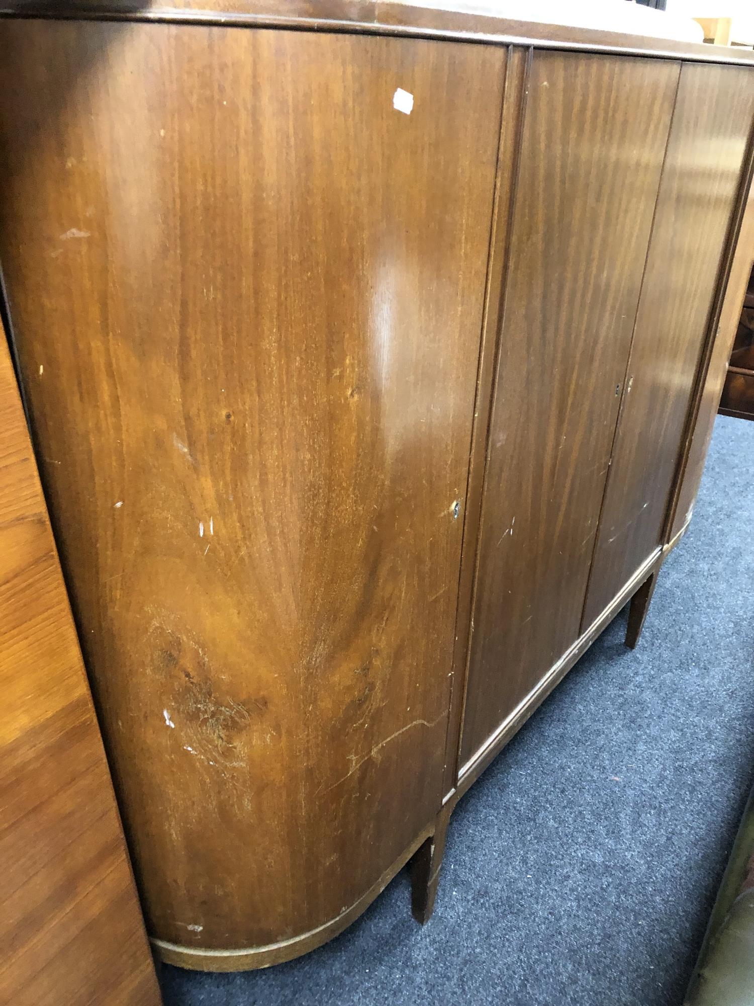 A mid 20th century teak four door sideboard on raised legs - Image 4 of 6