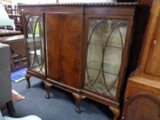 An Edwardian mahogany breakfront triple door bookcase on claw and ball feet